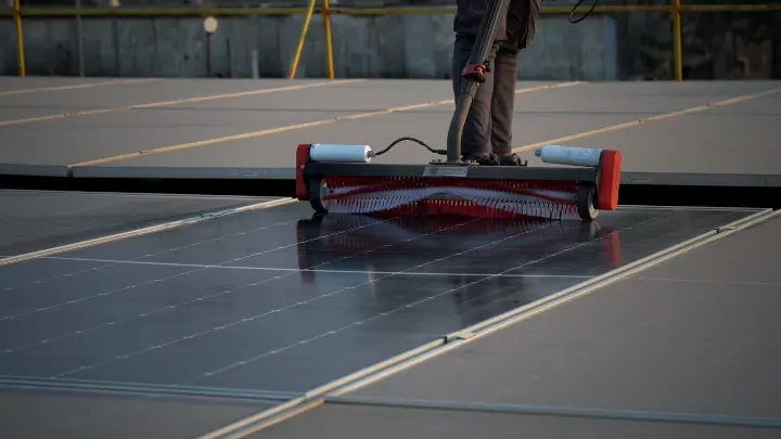 Aqualess Industrial cleaner moving across a rooftop solar panel