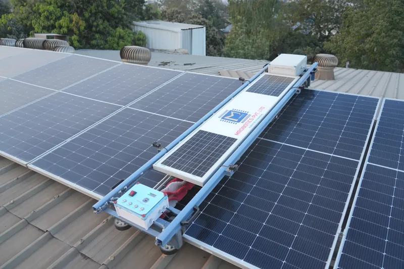 Solar Glide robot fitted across a rooftop solar row