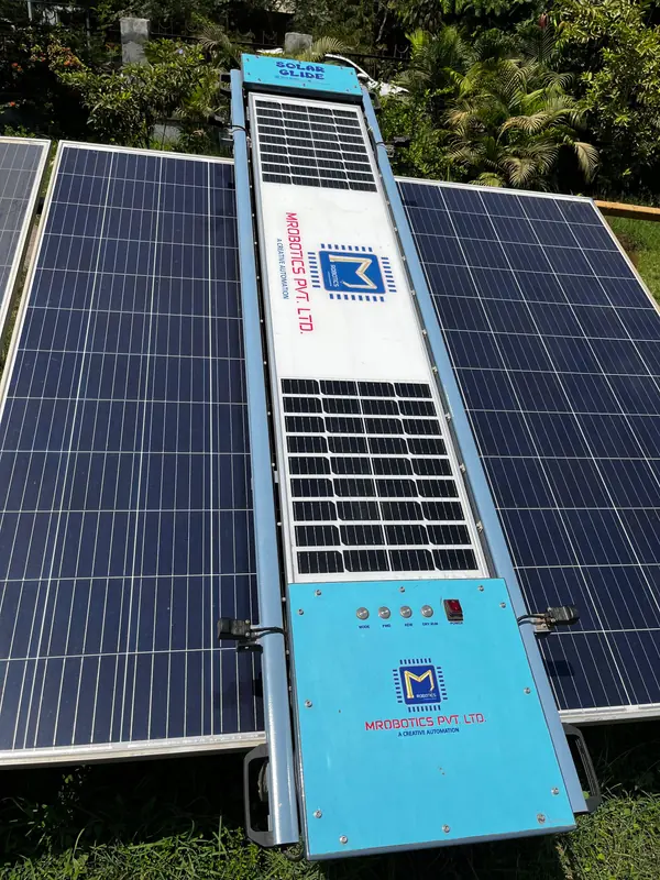 Solar Glide PRO robot with its own solar panel on a ground-mounted array